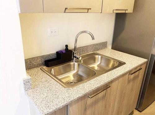 a kitchen counter with a stainless steel sink at Luxury Santo Domingo Tower Condo in Santo Domingo
