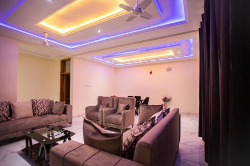 a living room with couches and a ceiling with blue lights at SMK Apartment in Ho