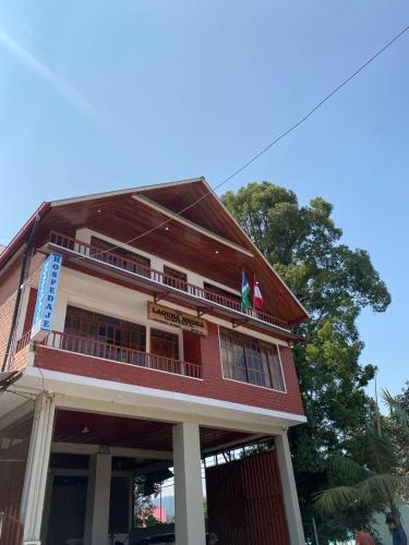 a building with two flags on top of it at LagunaNegra Oxapampa in Palmira