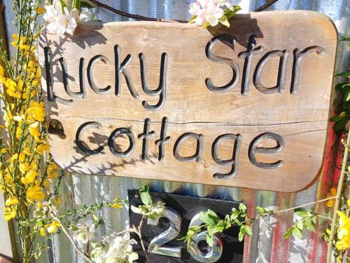a sign that reads kickin star guidance with flowers at Star Gaze From Your Bed in Fairlie