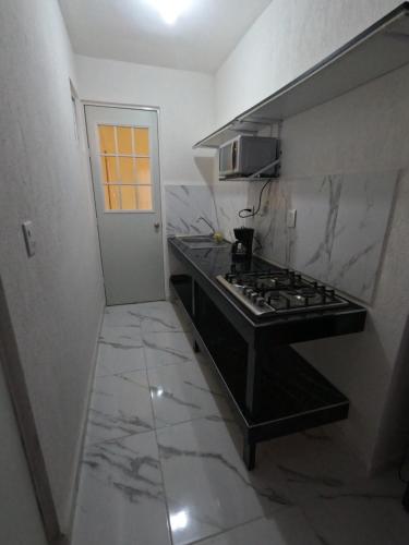 a kitchen with a stove and a counter top at Family Department in Tulum