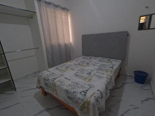 a bedroom with a bed with a blanket on it at Family Department in Tulum