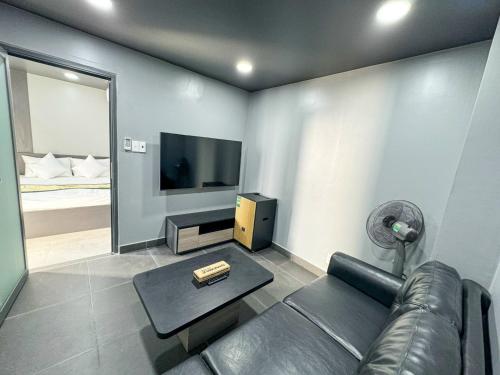 a living room with a couch and a flat screen tv at Queen Sea Resort - Đảo Phú Quý in Cu Lao Thu