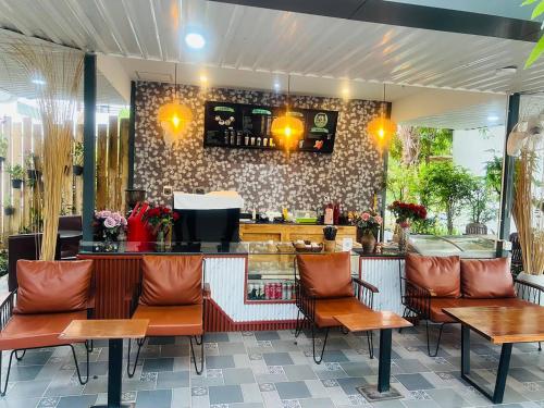 a restaurant with chairs and a counter with a bar at Tanei Angkor Resort and Spa in Siem Reap