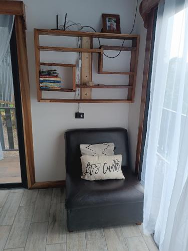a black chair with a pillow on it in a room at Athila Ecolove in Monteverde Costa Rica