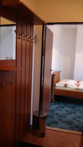 a room with a bedroom with a bed and a mirror at Penzion Taferna in Žďár nad Sázavou