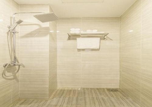 a bathroom with a shower with a glass door at Trang Ngan Hotel by THG in Danang