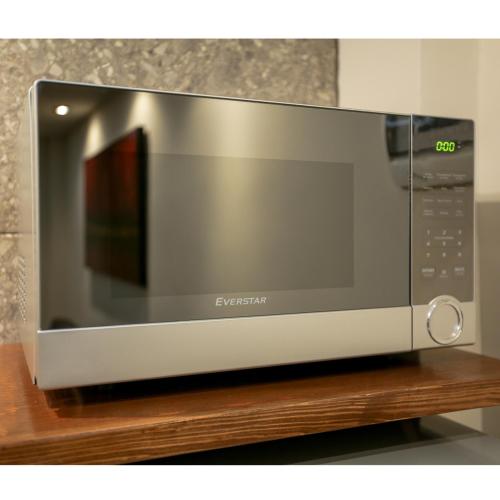 a microwave oven sitting on top of a wooden shelf at Royal Suite Cananea in Cananea