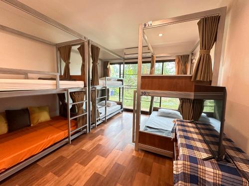 a room with three bunk beds in it at Sleep Soundly By The Sea in Trat