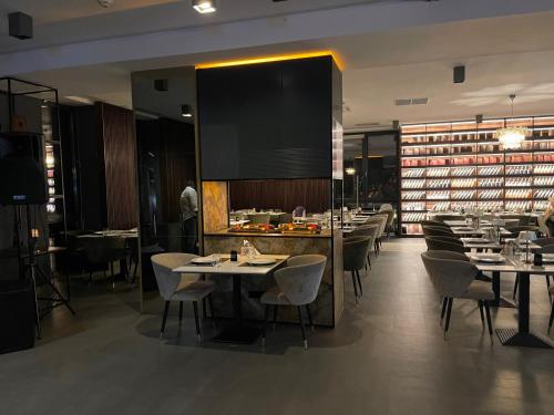 a dining room with tables and chairs in a restaurant at Montana Luxury Vue in Poiana Brasov