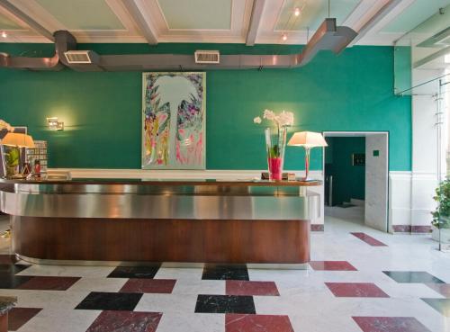 a bar in a lobby with a green wall at Ateneo Garden Palace in Rome