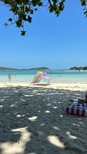 a beach with a kite on the sand and the water at Dikachaya Hostel in Chaweng