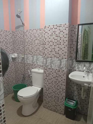 a bathroom with a toilet and a sink at Dreamway House Bed & Breakfast in Roxas City