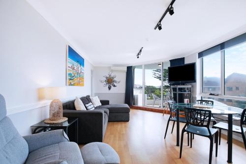 a living room with a couch and a table at Seascape Sanctuary - Palm Beach Resort-style Bliss in Gold Coast