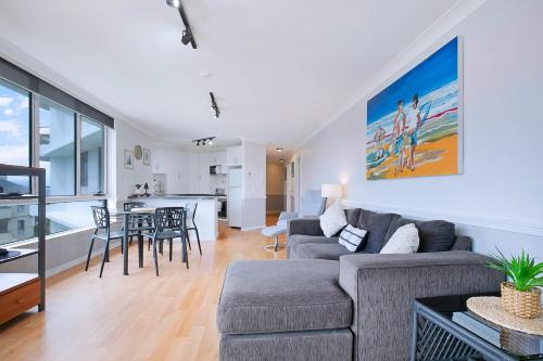 a living room with a couch and a table at Seascape Sanctuary - Palm Beach Resort-style Bliss in Gold Coast