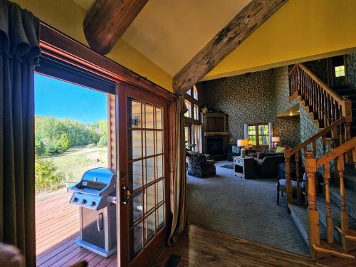 a living room with a large sliding glass door with a view at Chanticleer Cabins in Sturgeon Bay