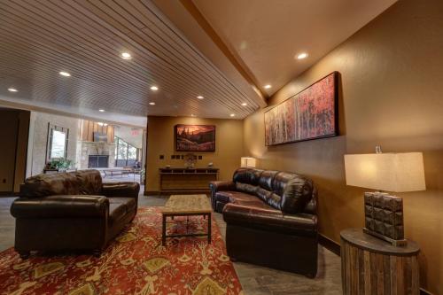 a living room with two leather couches and a table at MP613H Mountain Plaza Hotel Room Hotel Room in Copper Mountain