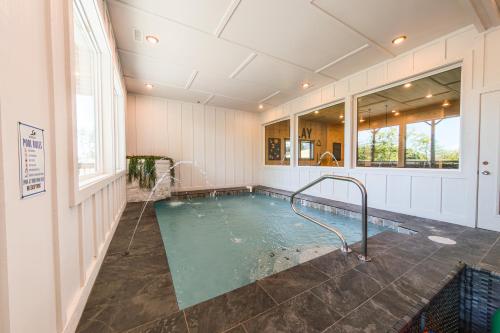 a swimming pool in a large room with at Luxury 12-Bedroom Cabin with Indoor Pool, Hot tub & Movie Theater, Sleeps 36 in Sevierville