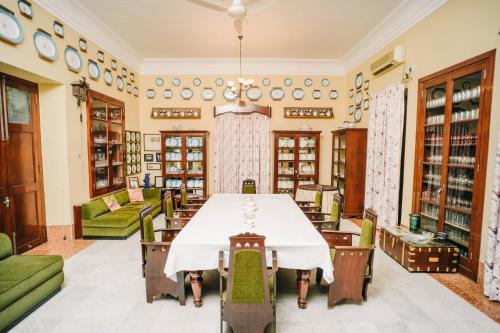 a dining room with a table and chairs at Nilambag Palace Hotel in Bhavnagar