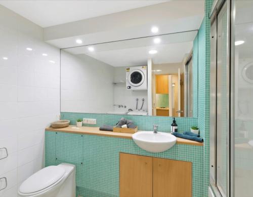 a bathroom with a sink and a toilet at The Entrance Waterfront Resort, Unit 614 in The Entrance