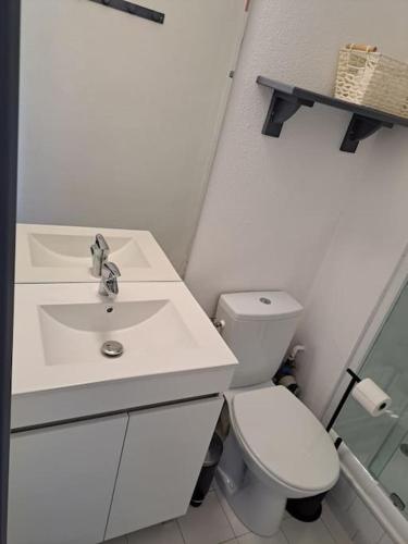 une salle de bain blanche avec un lavabo et des toilettes dans l'établissement Sopraland 514, T2 pour 5 pers, piscine, petite vue mer, au Cap d'Agde