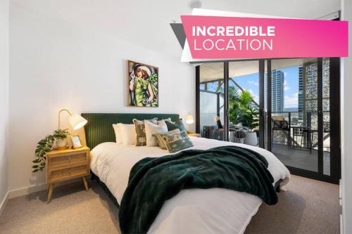 a bedroom with a bed and a sign that reads integrated location at Skyline Retreat - 2BR Luxury City Apartment in Adelaide