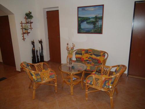 a dining room with a glass table and chairs at Penzion Taferna in Žďár nad Sázavou