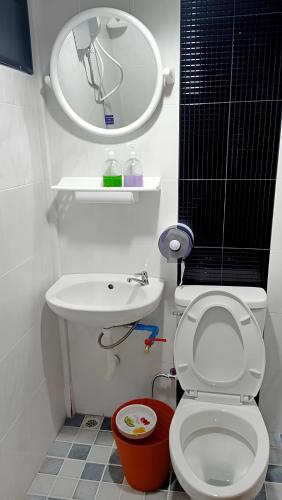 a small bathroom with a toilet and a sink at Sroysuwan Pool villa in Khanom