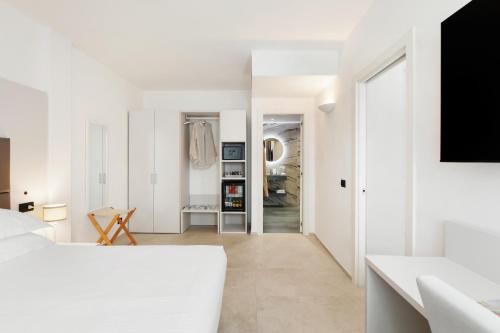 a white apartment with white walls and a hallway at Hotel Villa Domizia in Porto Santo Stefano