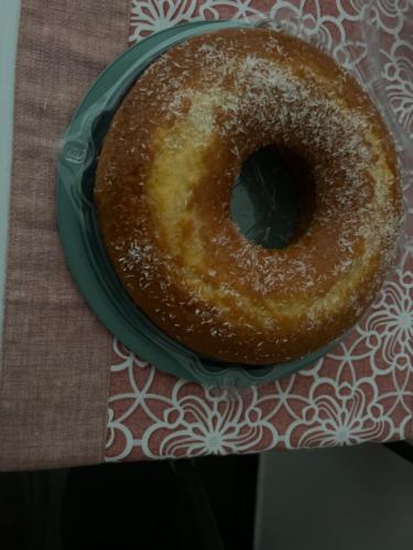 a doughnut sitting on a plate on a table at B&B Ladislaus in Ladispoli