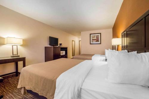 a hotel room with a large bed with white pillows at Quality Inn Post Falls - Coeur d'Alene in Post Falls