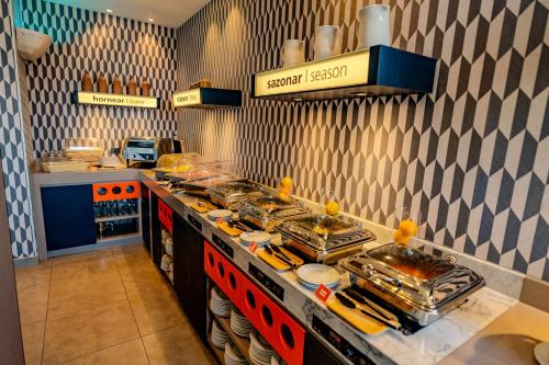 a kitchen with a buffet with food on it at Hampton By Hilton Santiago Las Condes in Santiago