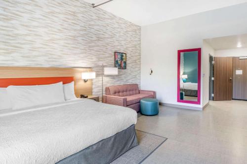 a hotel room with a bed and a chair at Home2 Suites Lexington Keeneland Airport, Ky in Lexington