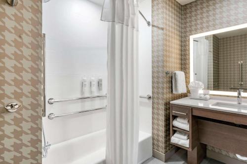 a bathroom with a shower and a sink at Home2 Suites Lexington Keeneland Airport, Ky in Lexington