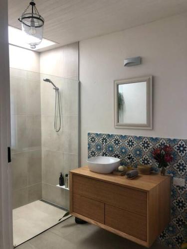 a bathroom with a sink and a shower at Redruth,original 1940 Falmouth shack in Falmouth