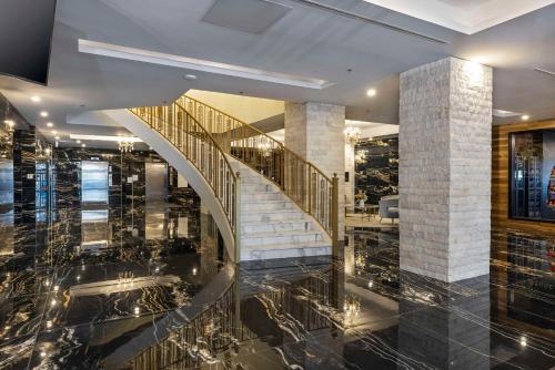 a lobby with a spiral staircase in a building at Halifax Tower Hotel & Conference Centre, an Ascend Collection Hotel in Halifax