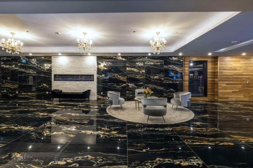 a lobby with a table and chairs and a fireplace at Halifax Tower Hotel & Conference Centre, an Ascend Collection Hotel in Halifax
