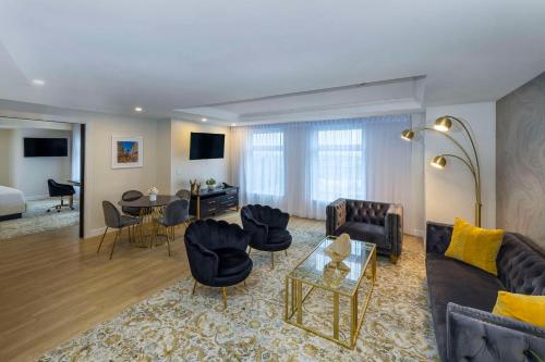 a living room with a couch and chairs and a table at Halifax Tower Hotel & Conference Centre, an Ascend Collection Hotel in Halifax