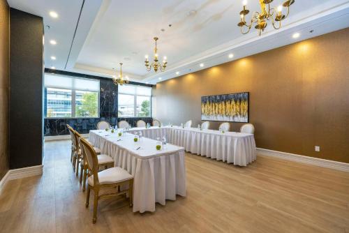a conference room with tables and chairs and a wall with windows at Halifax Tower Hotel & Conference Centre, an Ascend Collection Hotel in Halifax