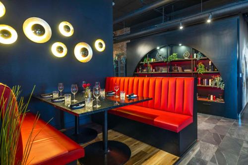 a dining room with a red bench and a table at Halifax Tower Hotel & Conference Centre, an Ascend Collection Hotel in Halifax