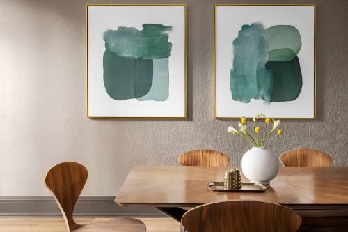 a dining room with a table and two pictures on the wall at The American Hotel Atlanta Downtown, Tapestry Collection by Hilton in Atlanta