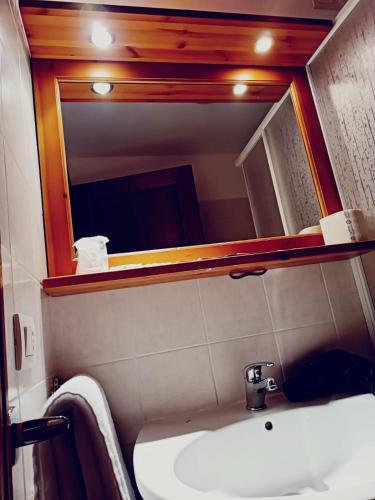 a bathroom with a sink and a mirror at Ai canipai in San Romano in Garfagnana