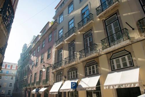a tall building with balconies on the side of it at Páteo Saudade Lofts in Lisbon