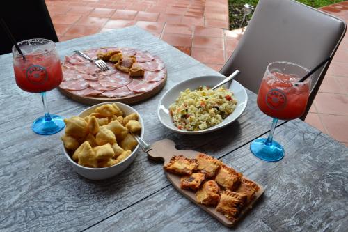a table topped with plates of food and drinks at Ai canipai in San Romano in Garfagnana