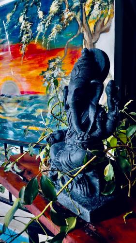a statue of a woman sitting on a bench next to a tree at Singh Brothers in Adams Peak