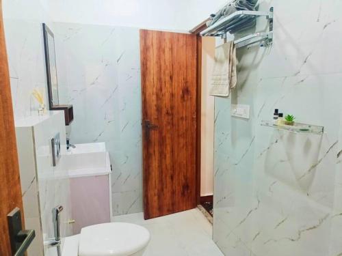 a bathroom with a toilet and a sink and a shower at 58 Paraiso Villa in Udaipur