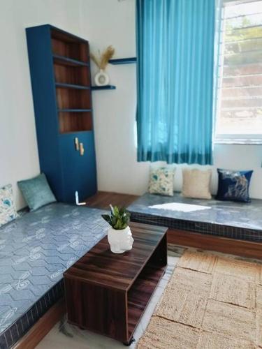 a living room with a bed and a couch at 58 Paraiso Villa in Udaipur