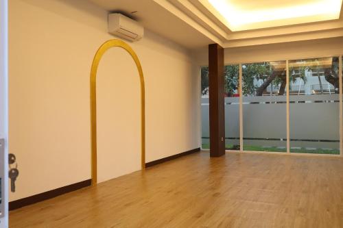 an empty room with a hallway with a gold arch on the wall at The Victoria Hotel Yogyakarta in Yogyakarta