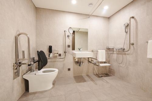 a bathroom with a toilet and a sink at Stanford Hotel Myeongdong in Seoul