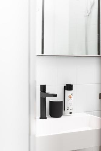 a bathroom with a sink and a mirror at Boutiquehotel Drei Ringe Schwörstadt - Rheinfelden in Schwörstadt